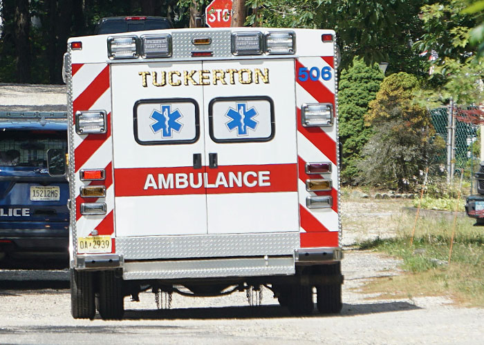 Ambulance vehicle parked near police car responding to woman&rsquo;s anaphylactic shock after brother-in-law&rsquo;s lunch lie