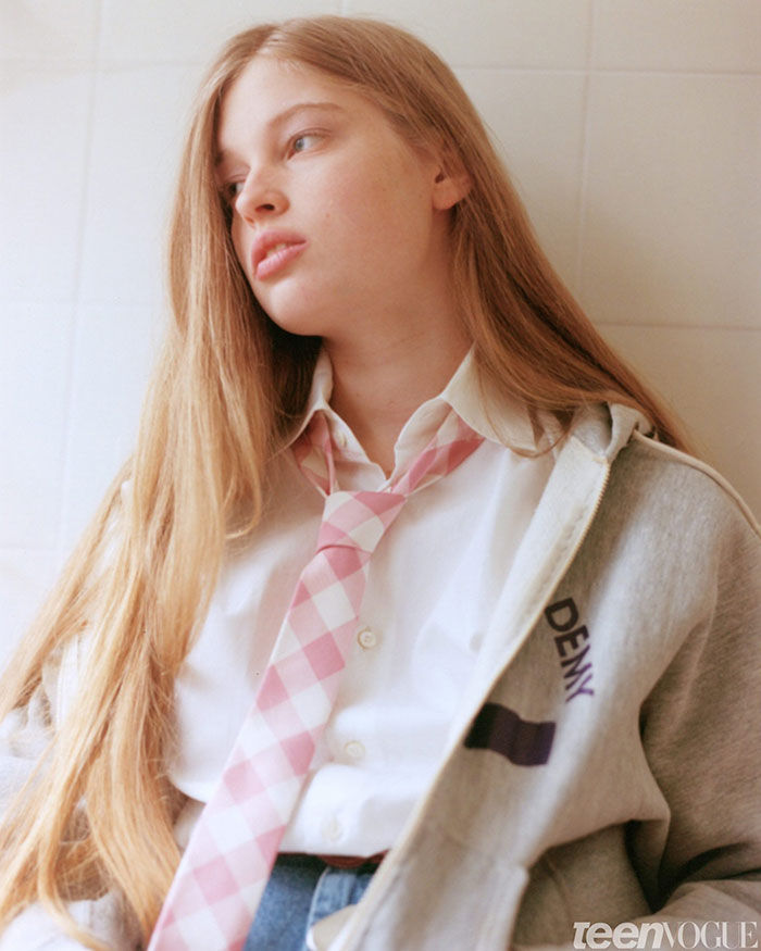 Young transgender woman with long hair wearing a pink checkered tie and casual clothing, looking thoughtfully away. Young transgender woman with long hair wearing a pink checkered tie and casual clothing, looking thoughtfully away.
