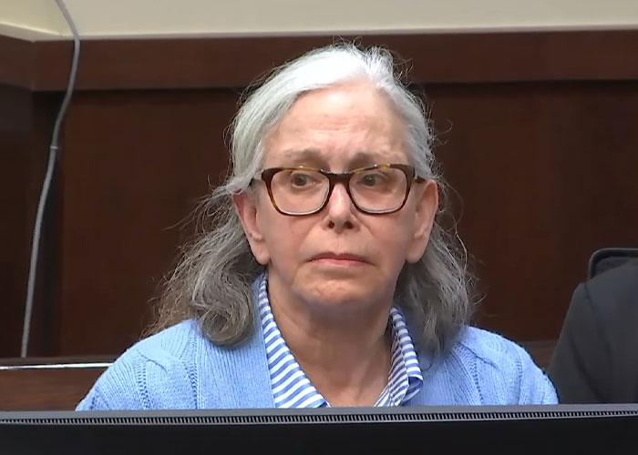 Elderly woman wearing glasses and a blue sweater in court during jury deliberation about a viral legal case.
