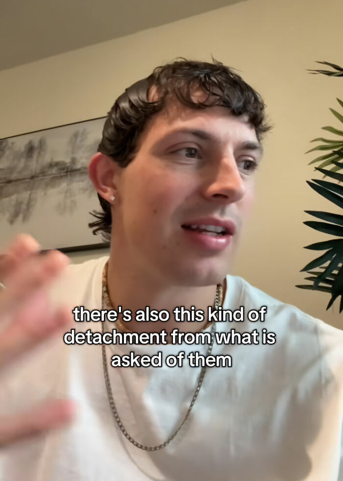 Therapist explaining Gen Z clients troubling behavior, wearing white shirt and chain, speaking in casual indoor setting. Therapist explaining Gen Z clients troubling behavior, wearing white shirt and chain, speaking in casual indoor setting.