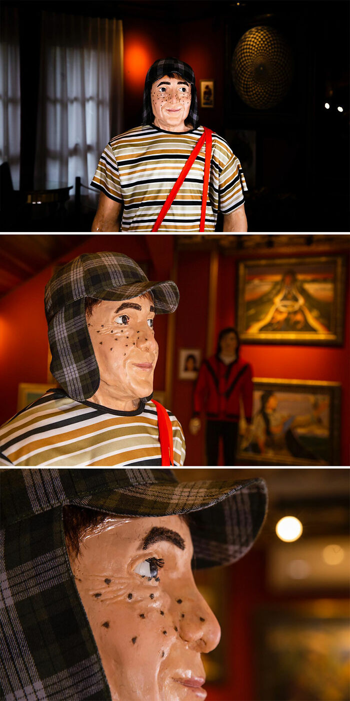 Wax sculpture of a freckled young figure wearing a plaid hat and striped shirt, showcasing creepy and hilarious artistry.