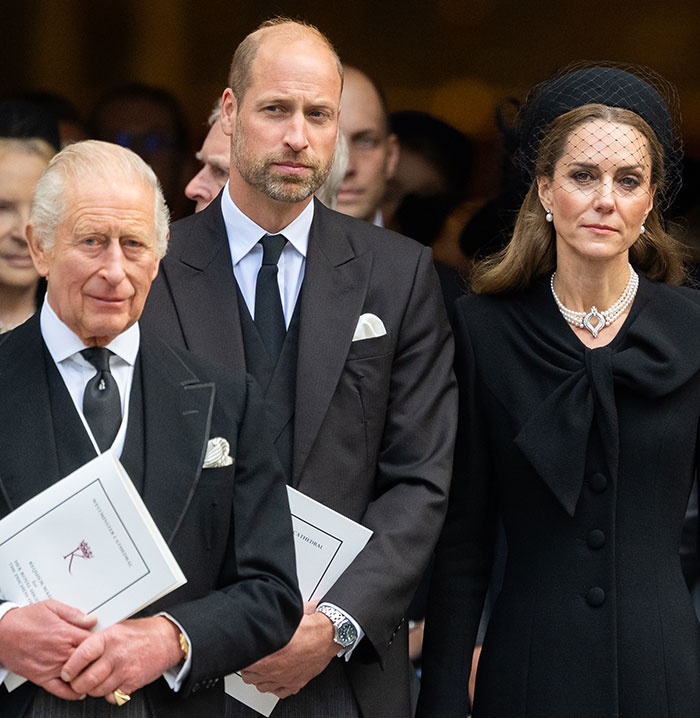 King Charles, Kate Middleton, and Prince William dressed in black attending a royal funeral ceremony.