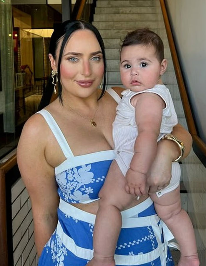 Woman holding a healthy oversized baby indoors, highlighting concerns over the rise in giant baby births by doctors. Woman holding a healthy oversized baby indoors, highlighting concerns over the rise in giant baby births by doctors.