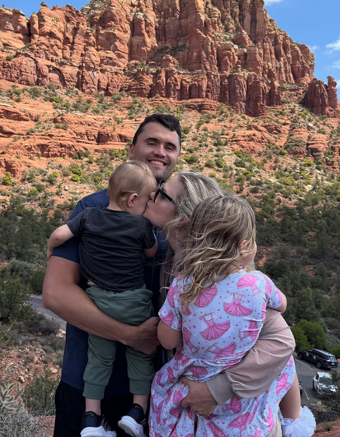 Family embracing outdoors with red rock cliffs in the background, reflecting on justice and farewell gathering.