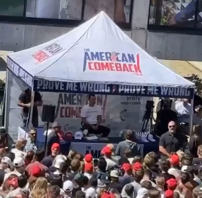 Crowd gathered near a tent at an event where neighbors discuss Tyler Robinson’s trans partner disappearance. Crowd gathered near a tent at an event where neighbors discuss Tyler Robinson’s trans partner disappearance.