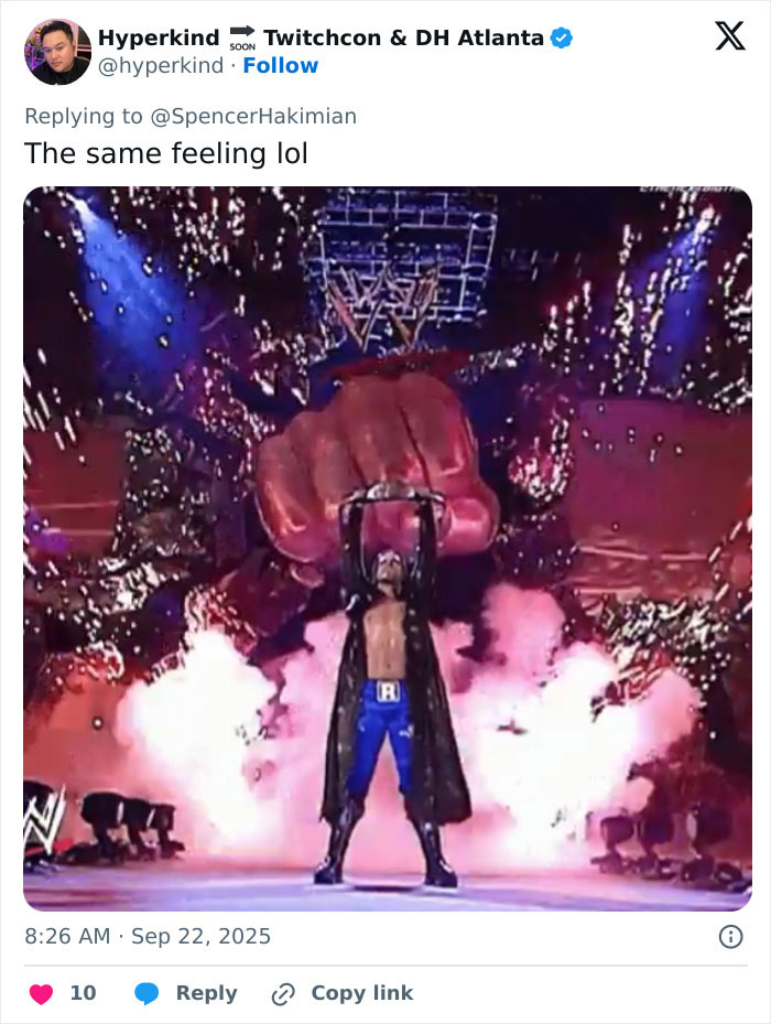 WWE level entrance with dramatic pyrotechnics and a large fist prop during a surprising moment on stage WWE level entrance with dramatic pyrotechnics and a large fist prop during a surprising moment on stage