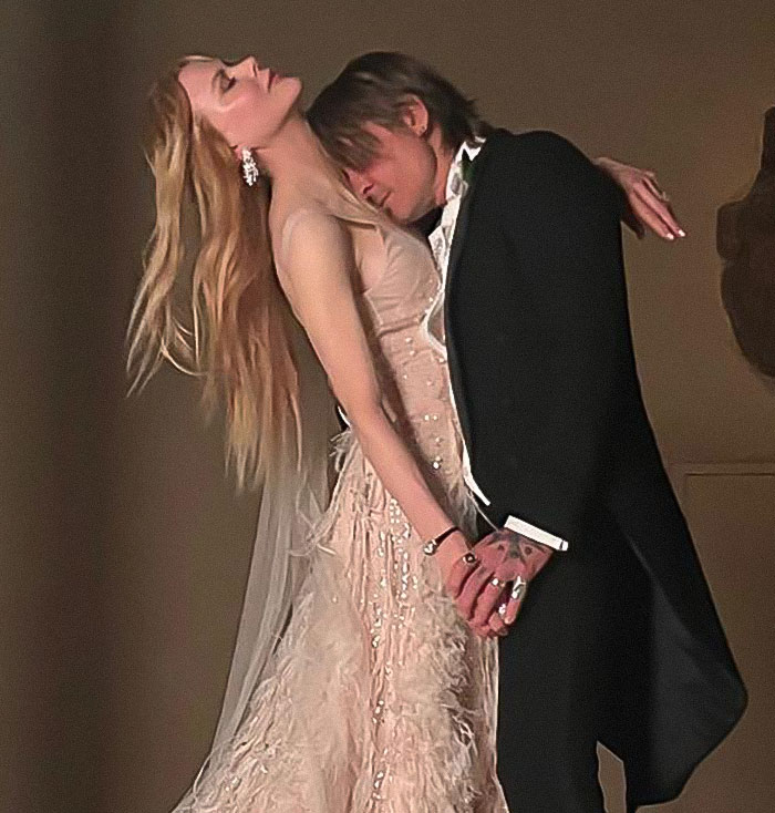 Nicole Kidman and Keith Urban holding hands in an emotional pose, highlighting clues of their rumored split.