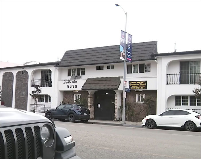 Apartment building exterior with parked cars, related to American Nightmare mom found lifeless after online marriage.