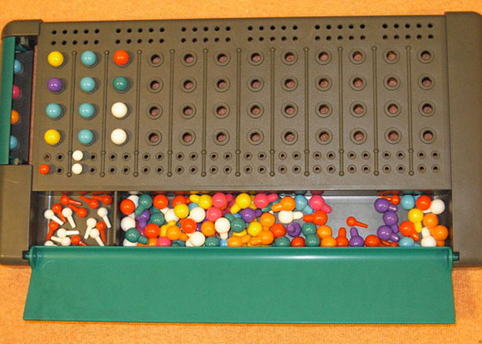 Mastermind game board with colorful pegs creating patterns, illustrating incredible coincidences that seem fake but are true.