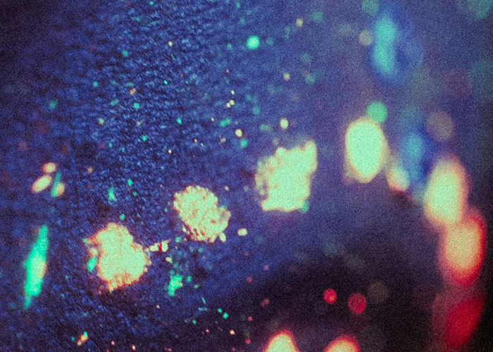 Close-up of glowing paint spots revealing hidden gems discovered after moving into a new home under UV light.