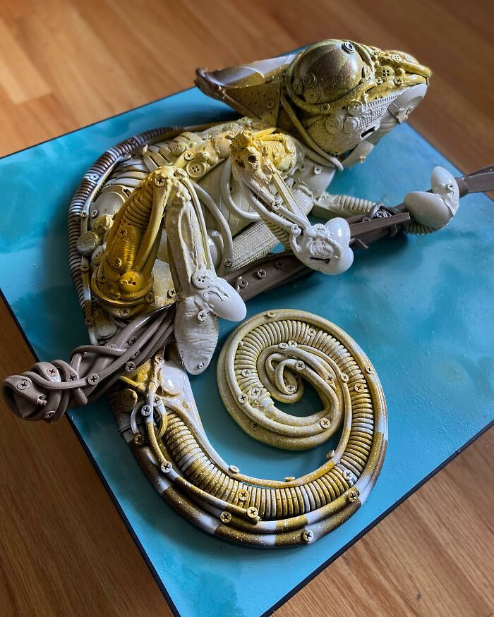 Chameleon sculpture made from recycled trash and found objects, showcasing stunning animal art and creative reuse.