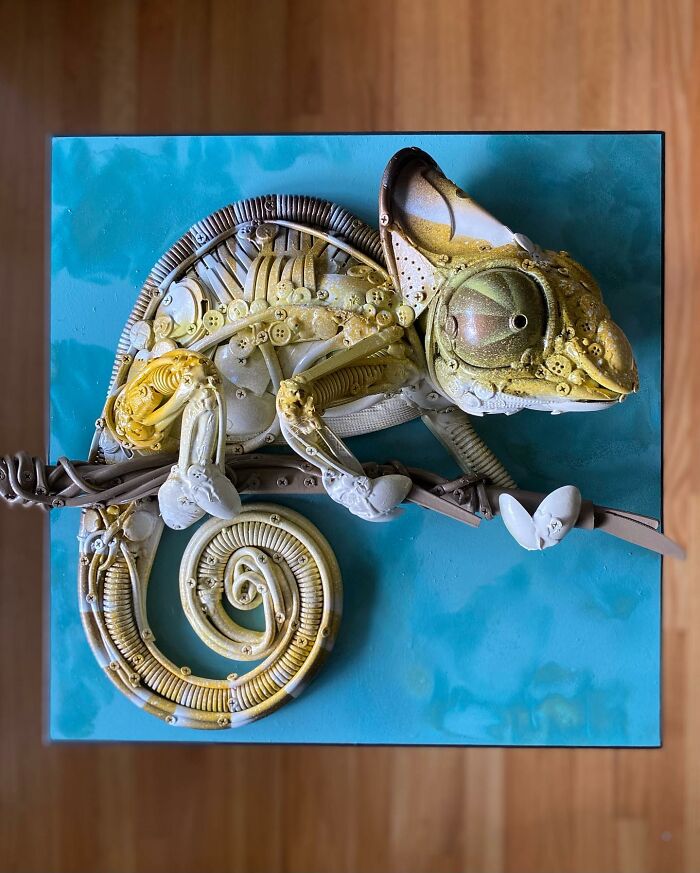 Chameleon sculpture made from recycled trash and found objects, showcasing stunning animal art and creative reuse.