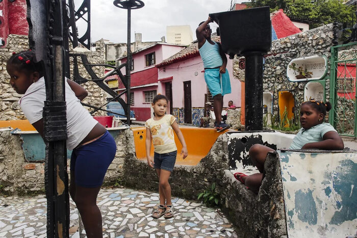 Children of the world playing outdoors in a vibrant urban setting, captured in powerful photographs by Andrea Torrei