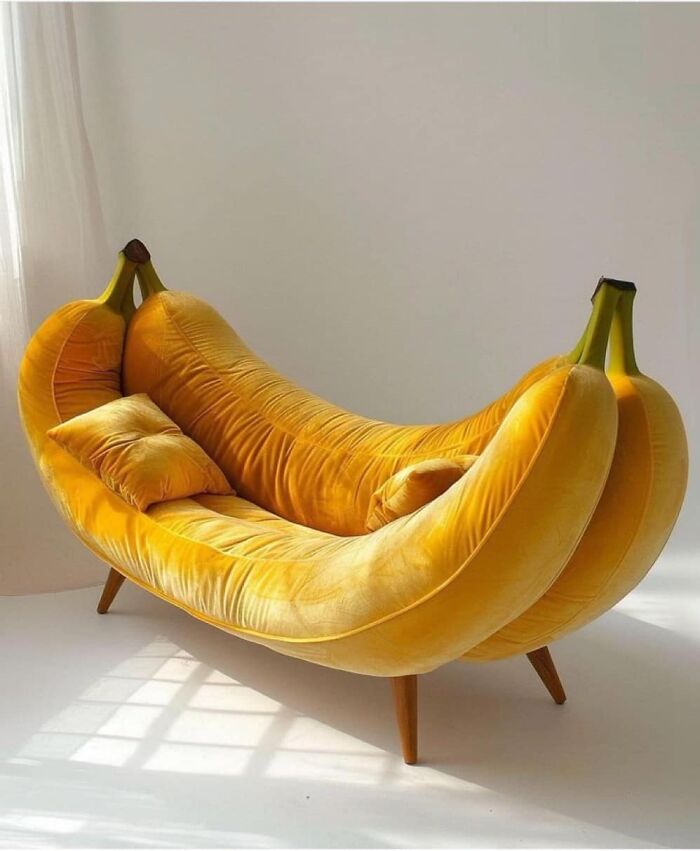 Banana-shaped couch in bright yellow velvet fabric with wooden legs and matching pillows, a weird purchase people would make.