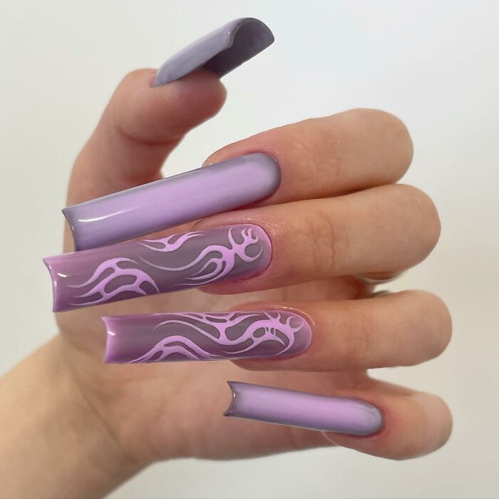 Long purple nails with flame-inspired nail designs in light and dark shades, showcasing unique nail designs.
