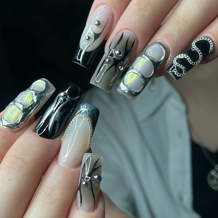 Unique black and silver 3D nail designs breaking all the rules with bold patterns and textured embellishments on long nails.