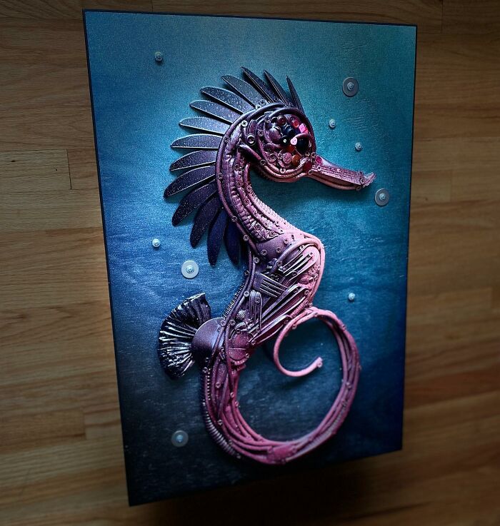 Seahorse sculpture made from recycled metal parts, showcasing stunning animal sculptures created from trash by this artist.