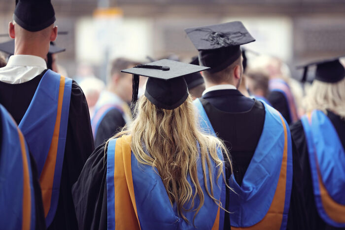 Graduates wearing caps and gowns at a ceremony, symbolizing the moment they realized they had fallen out of love.
