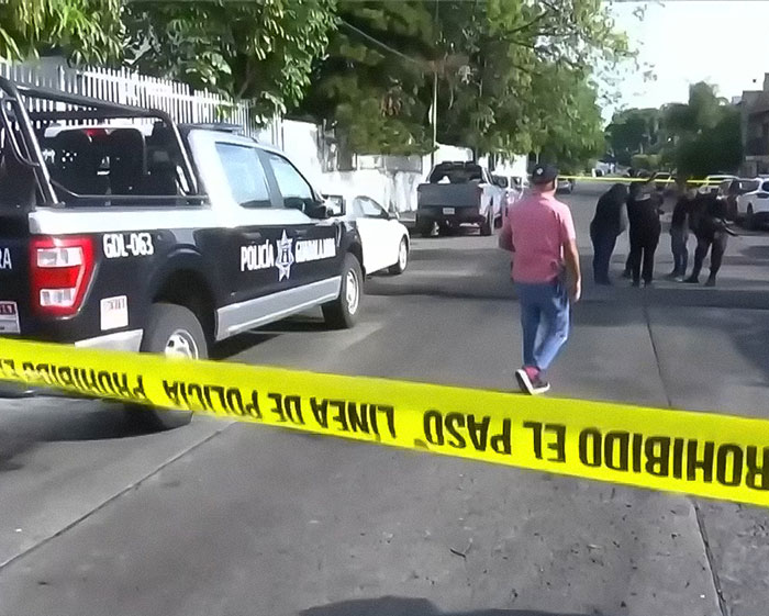 Police vehicle and officers at a crime scene with yellow tape investigating the body of influencer Esmeralda Ferrer Garibay. Police vehicle and officers at a crime scene with yellow tape investigating the body of influencer Esmeralda Ferrer Garibay.