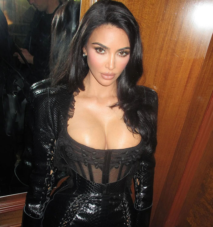 Kim Kardashian posing in a black outfit amid controversy over North West&rsquo;s middle finger dermal piercing at age 12.