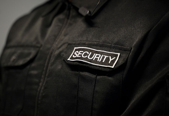 Close-up of a security guard uniform patch emphasizing security during a late night creepy incident on the job.
