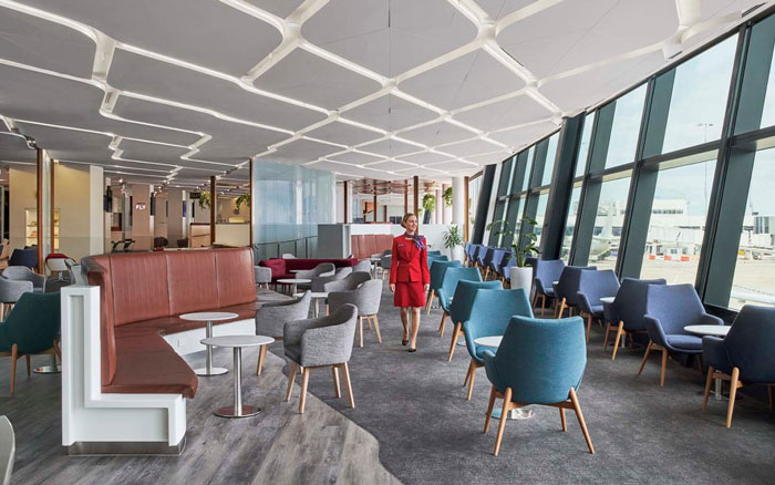 Virgin Australia lounge interior with flight attendant walking, related to doctor furious over pumping breast milk incident. Virgin Australia lounge interior with flight attendant walking, related to doctor furious over pumping breast milk incident.
