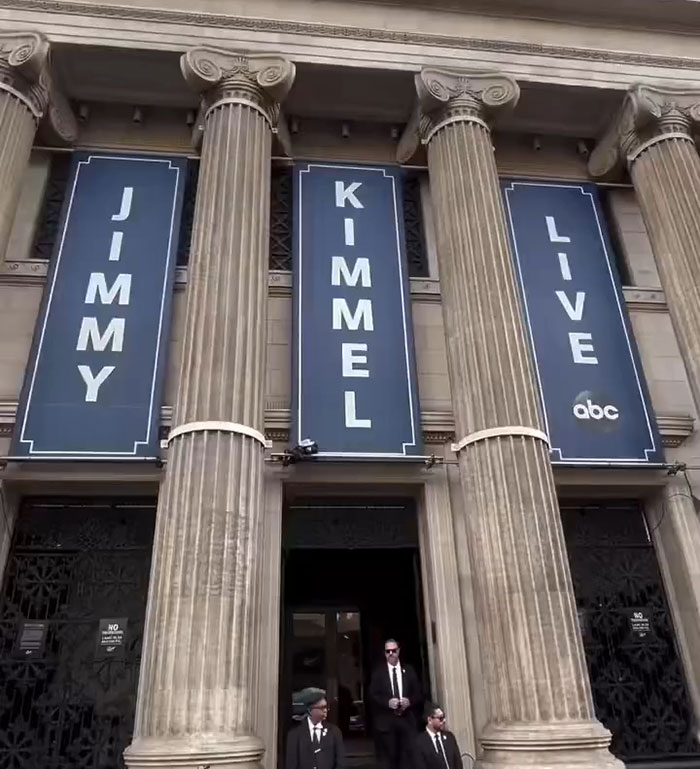 Facade of the Jimmy Kimmel Live studio with large banners and security guards outside, related to show suspension news. Facade of the Jimmy Kimmel Live studio with large banners and security guards outside, related to show suspension news.