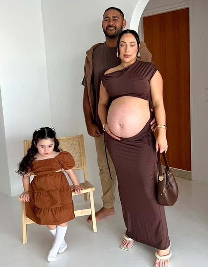 Pregnant woman with visible large belly standing with family, illustrating concerns about giant baby births from doctors. Pregnant woman with visible large belly standing with family, illustrating concerns about giant baby births from doctors.