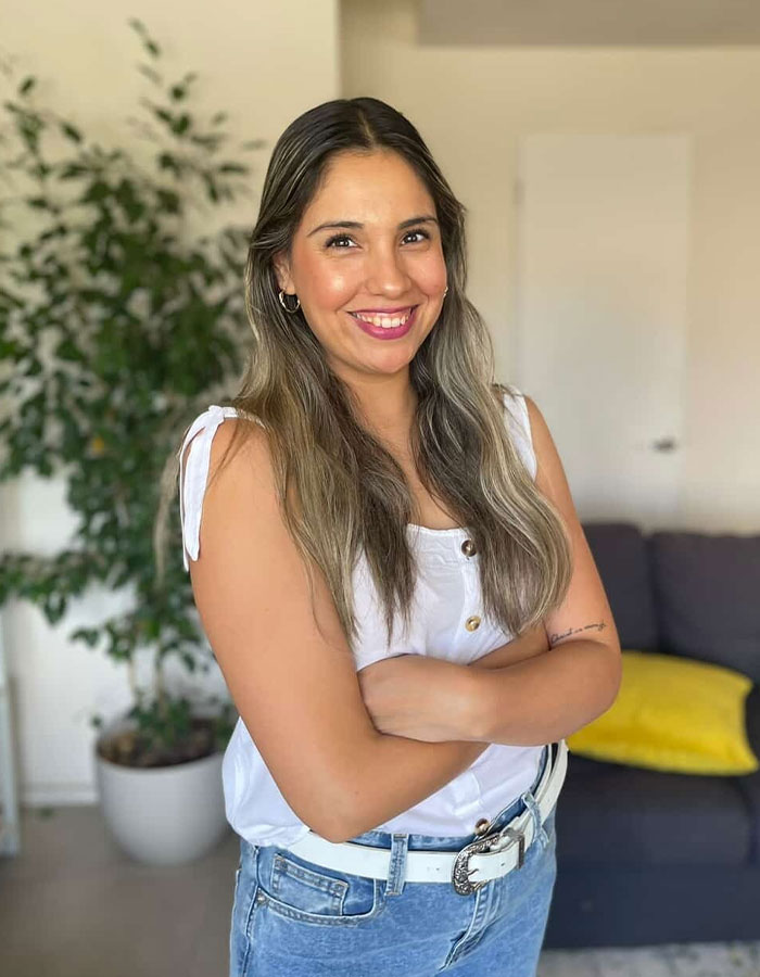 Smiling woman food engineer with long hair stands confidently indoors, exposing supermarket products that trick millions of shoppers.