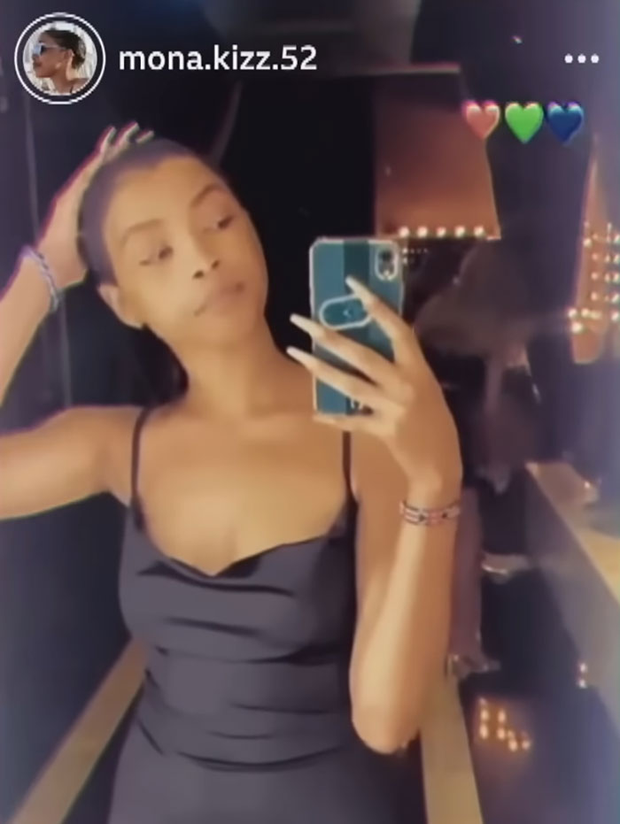 Young woman taking a selfie in a mirror, highlighting her experience about Dubai's infamous porta potty parties.