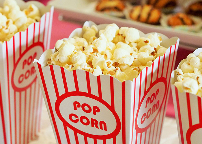 Popcorn in red and white striped containers, representing common purchases ditched due to ridiculous price tags.