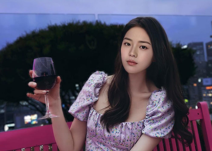 Young woman holding a glass of red wine outdoors at dusk, related to Emily Blunt and AI actress Tilly Norwood. Young woman holding a glass of red wine outdoors at dusk, related to Emily Blunt and AI actress Tilly Norwood.