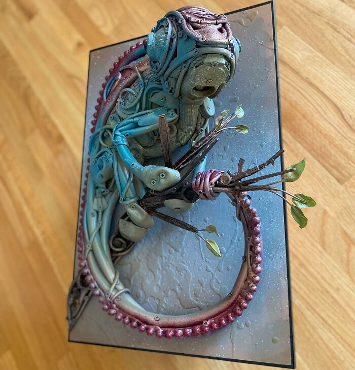 Intricate animal sculpture made from trash materials, showcasing vibrant colors and detailed recycled art craftsmanship.