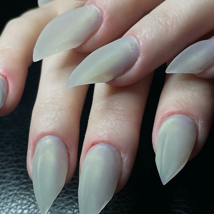 Close-up of long matte pointed nails showcasing one of the 50 nail designs that break all the rules and look amazing.