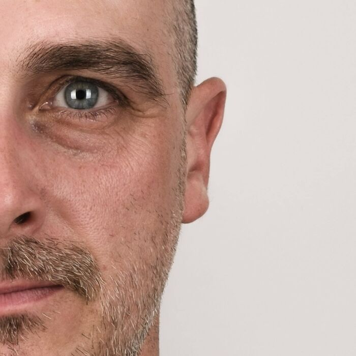 Portrait of a man with half his face younger and the other half older, illustrating strong family DNA traits side-by-side.