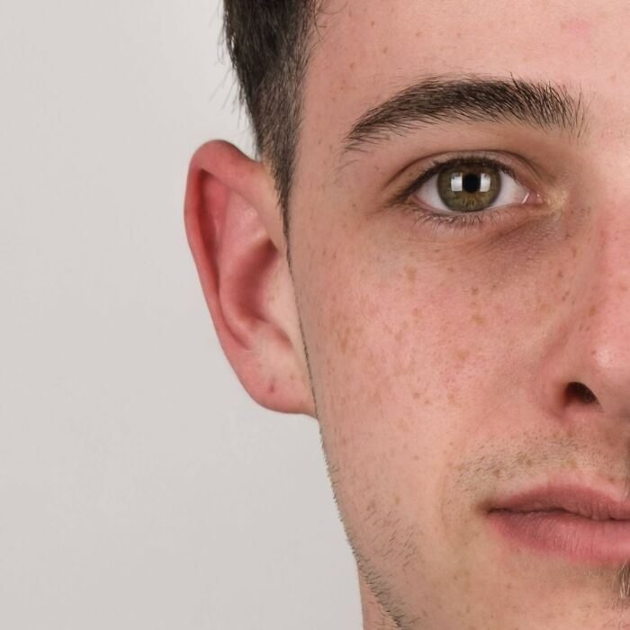 Portrait of a man with half his face younger and the other half older, illustrating strong family DNA traits side-by-side.