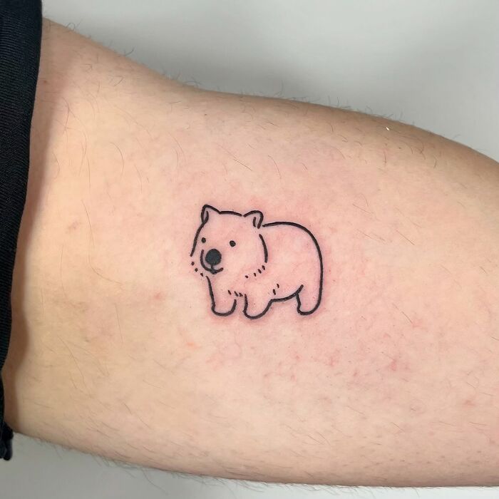 Minimalist bear tattoo on arm, showcasing adorable animal design by Korean artist Buoy, emphasizing cute and simple style.