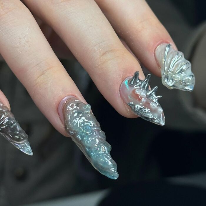 Avant-garde clear nail designs with 3D textured elements showcasing bold and unconventional nail art styles.