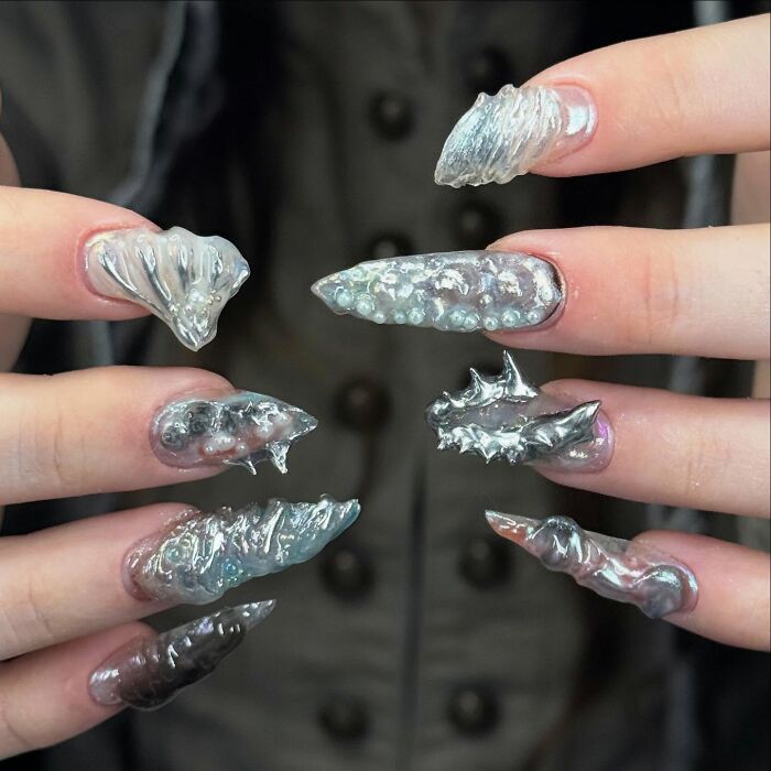 Avant-garde clear nail designs with 3D textured elements showcasing bold and unconventional nail art styles.