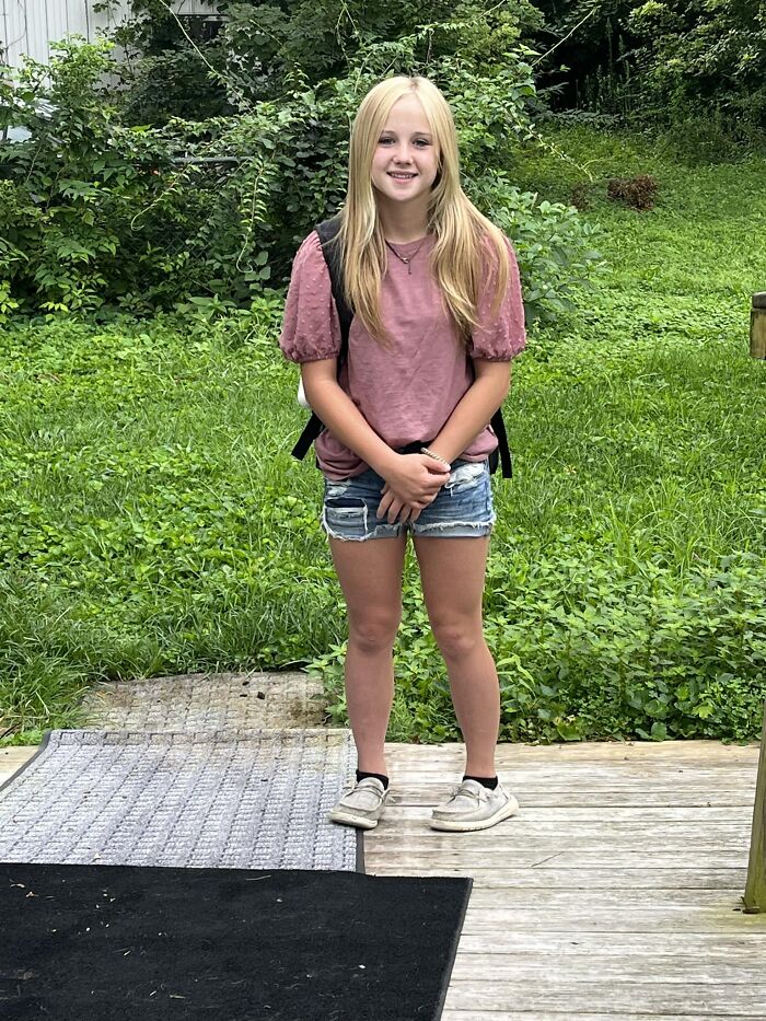 Teenage girl standing outside in casual clothes with greenery in the background, related to soul-crushing family tragedy. Teenage girl standing outside in casual clothes with greenery in the background, related to soul-crushing family tragedy.