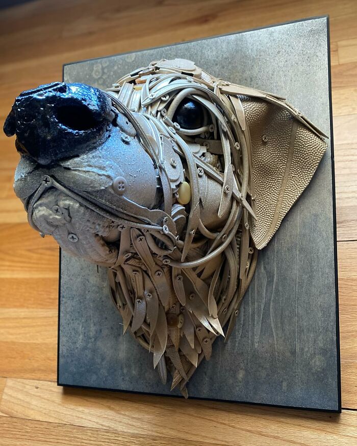 Dog sculpture made from trash materials, showcasing stunning animal sculptures created by a talented artist.
