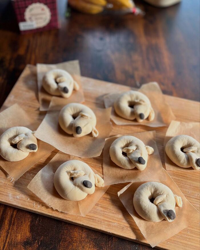 Creative meals for kids featuring dog-shaped bread rolls arranged in a basket lined with a cloth.