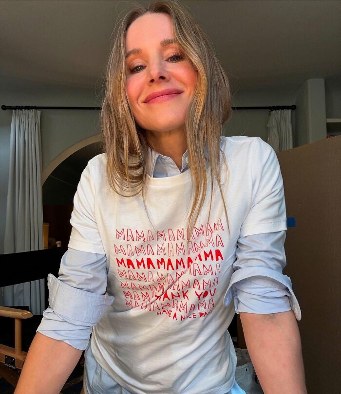 Kristen Bell smiling indoors wearing a white shirt, representing biohacking trick experts back to stay fit.