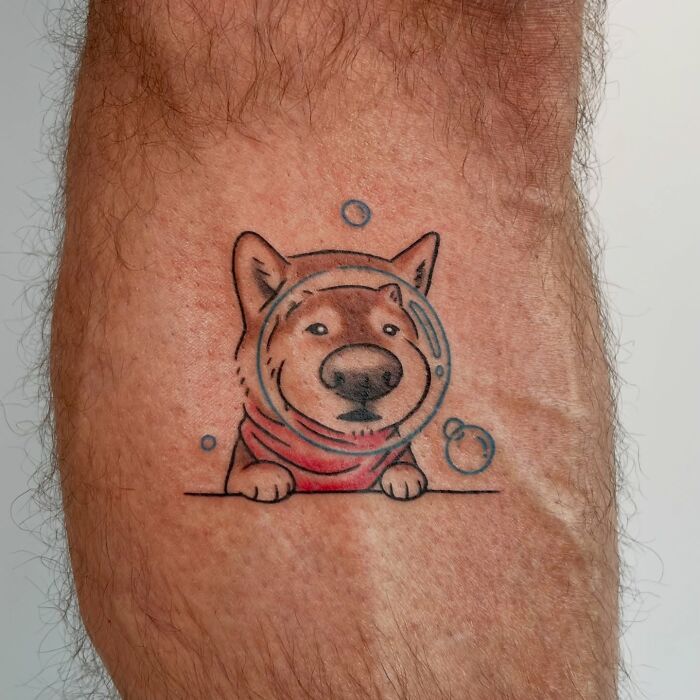Small dog tattoo with bubble design, part of adorable frog and animal tattoos by Korean artist Buoy on arm skin.