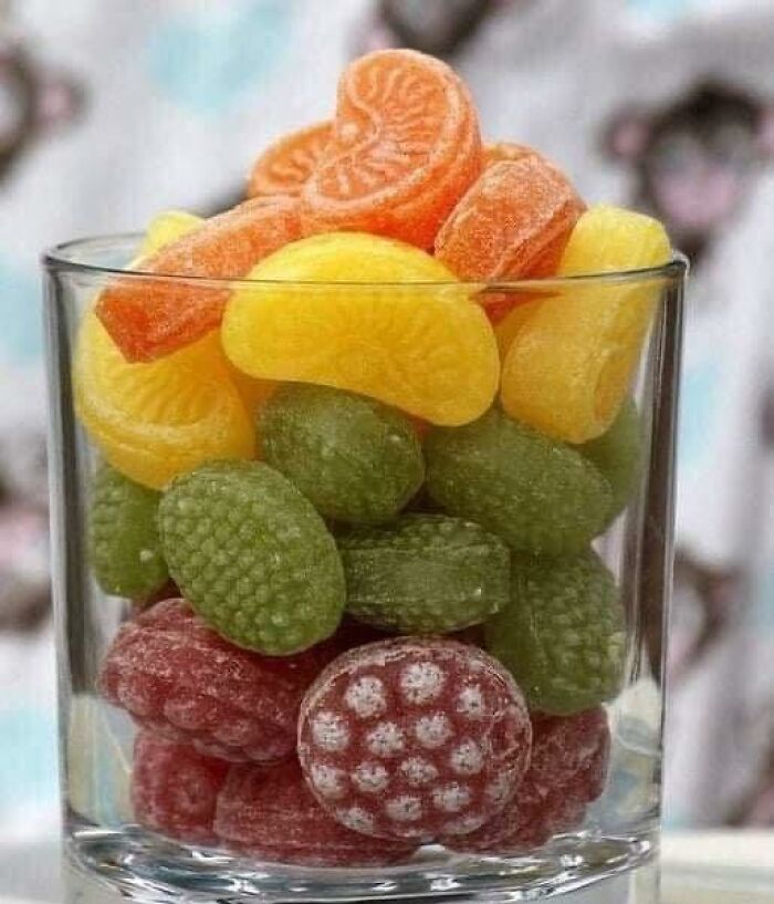 Colorful fruit-shaped candies in a glass bowl, a nostalgic treat many people raised in Eastern Europe recognize.