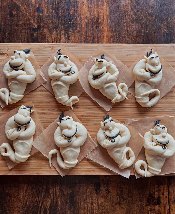 Creative meals baked as fun character-shaped bread rolls by a mom from Japan for her kids, sprinkled with coarse salt.