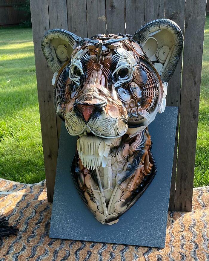 Animal sculpture made from recycled trash materials, showcasing intricate details and creative reuse in art.