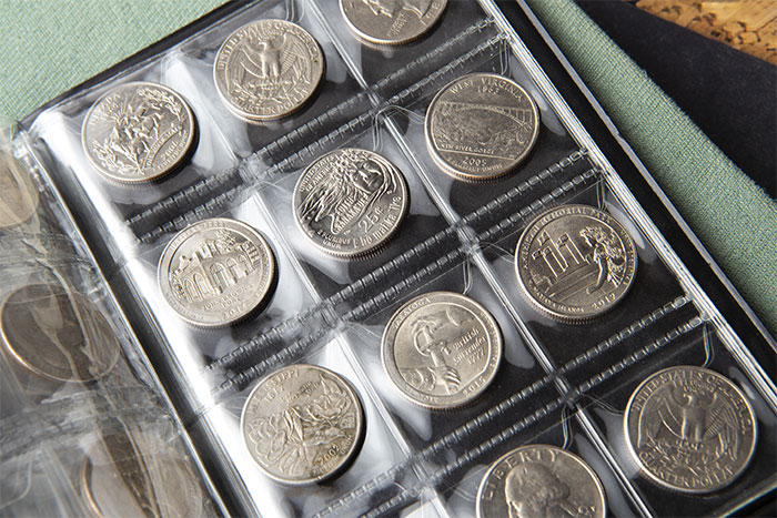 Collection of US state quarters in a plastic coin holder illustrating teen disappointment and hurt by parents' gift.