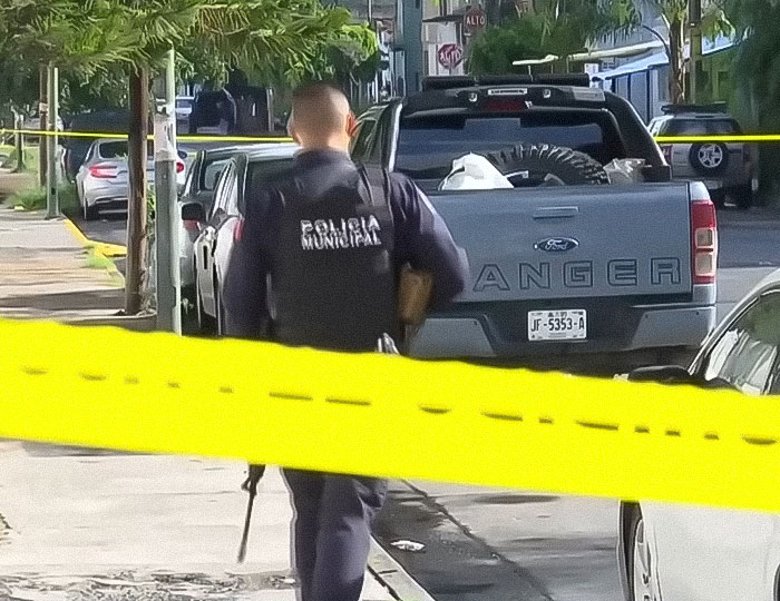 Police officer at a crime scene with yellow tape around an abandoned car linked to influencer Esmeralda Ferrer Garibay case. Police officer at a crime scene with yellow tape around an abandoned car linked to influencer Esmeralda Ferrer Garibay case.