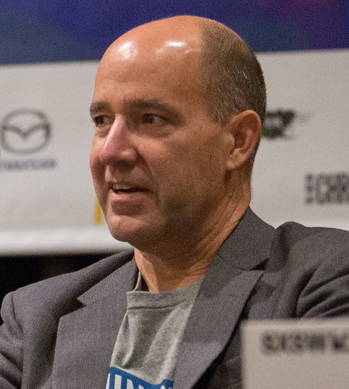 NBC analyst speaking at an event, wearing a gray blazer, following controversy over remarks about Charlie Kirk. NBC analyst speaking at an event, wearing a gray blazer, following controversy over remarks about Charlie Kirk.